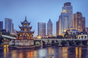 Traditional pagoda on a river beside a modern city skyline at dusk, reflecting adoption connections across cultures